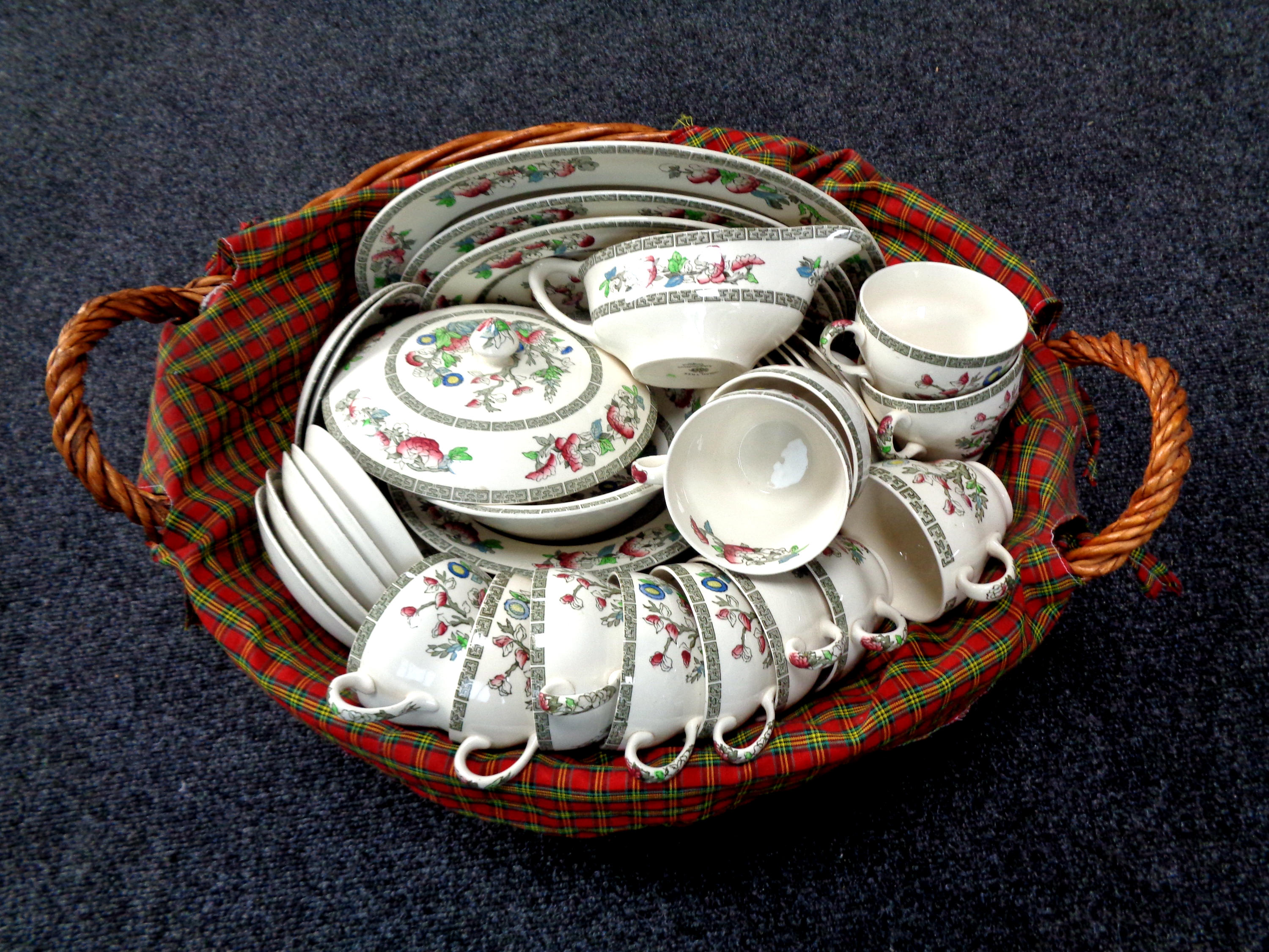 A wicker hamper containing a Johnson Brothers Indian tree dinner service