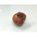 A carved Chinese hardwood netsuke - Two rats on a pot