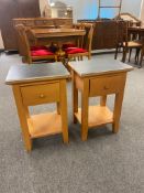 A pair of granite topped bedside stands