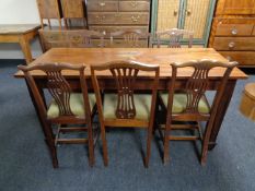 A mahogany dining table together with a set of six chairs with green draylon seats