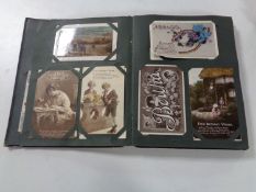 An early 20th century postcard album containing various monochrome and colour postcards depicting