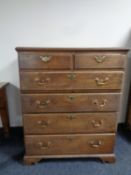 A George III oak chest of six drawers