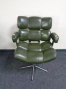 A 20th century green faux leather swivel desk chair on chrome support