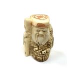 A carved Chinese bone netsuke - Village elder holding a staff