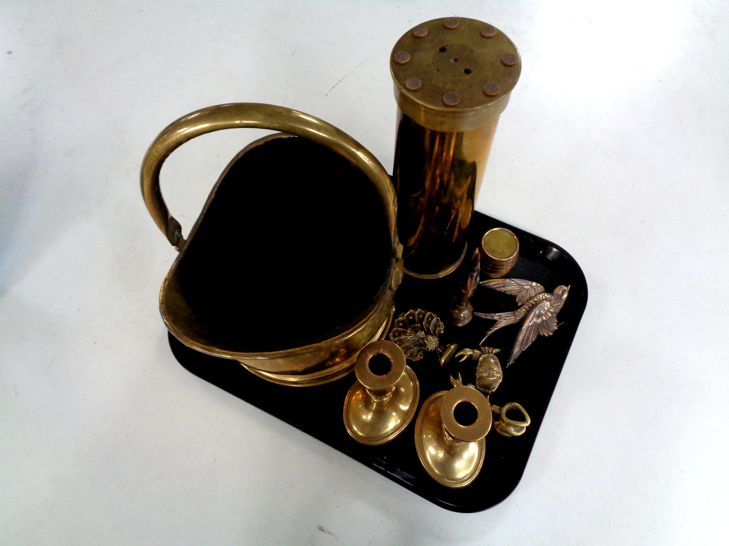 A tray containing brass ammunition, shell trench art ashtray, pair of brass candlesticks,