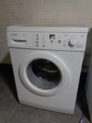 A Bosch Classixx 6 washing machine together with a sharp microwave