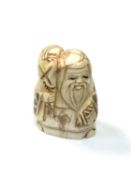 A carved Chinese bone netsuke - Elderly gentleman holding a sack on shoulder