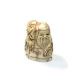 A carved Chinese bone netsuke - Elderly gentleman holding a sack on shoulder