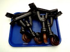 A tray containing a set of four heavy metal casters stamped Vono trademark B2B