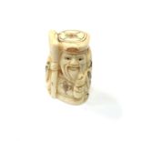 A carved Chinese bone netsuke - Gentleman holding staff and money bag