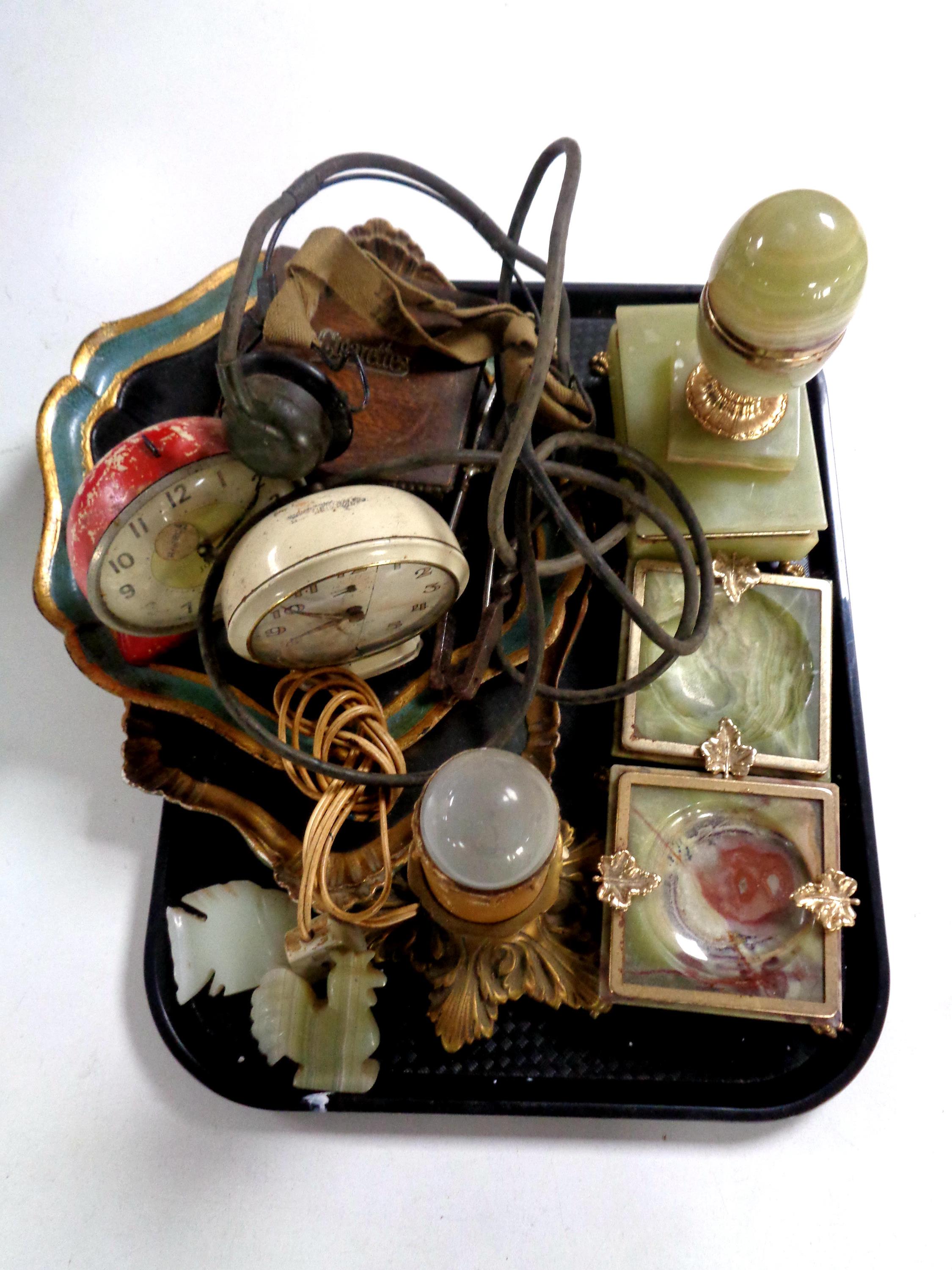 A tray containing onyx ashtrays, onyx trinket box on paw feet, gilt lamp base, nutcrackers,