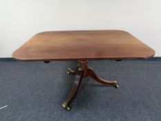 A 19th century mahogany pedestal breakfast table on brass casters