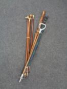 Two bundles of walking canes, umbrella with Scottie dog handle,