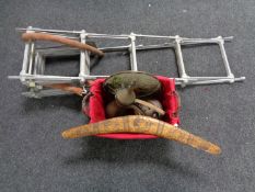 A wicker basket containing boomerang, copper teapot,