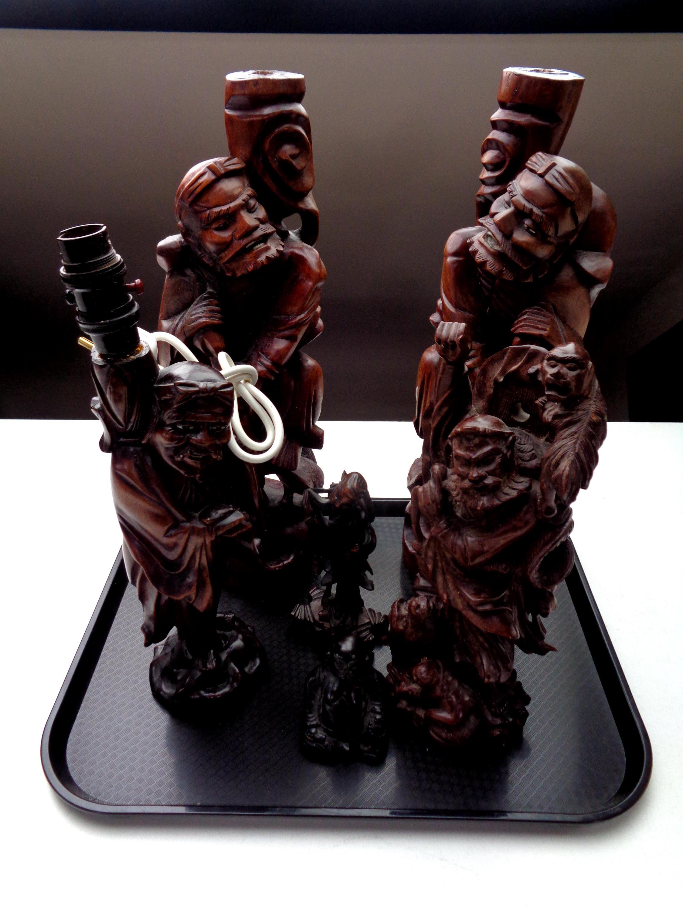 A tray containing Chinese carved hardwood figural table lamp, pair of large carved hardwood figures,