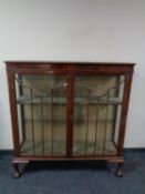 An early 20th century glazed mahogany display cabinet (as found)