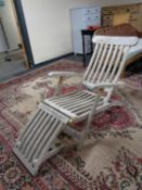 A teak and brass mounted garden lounger