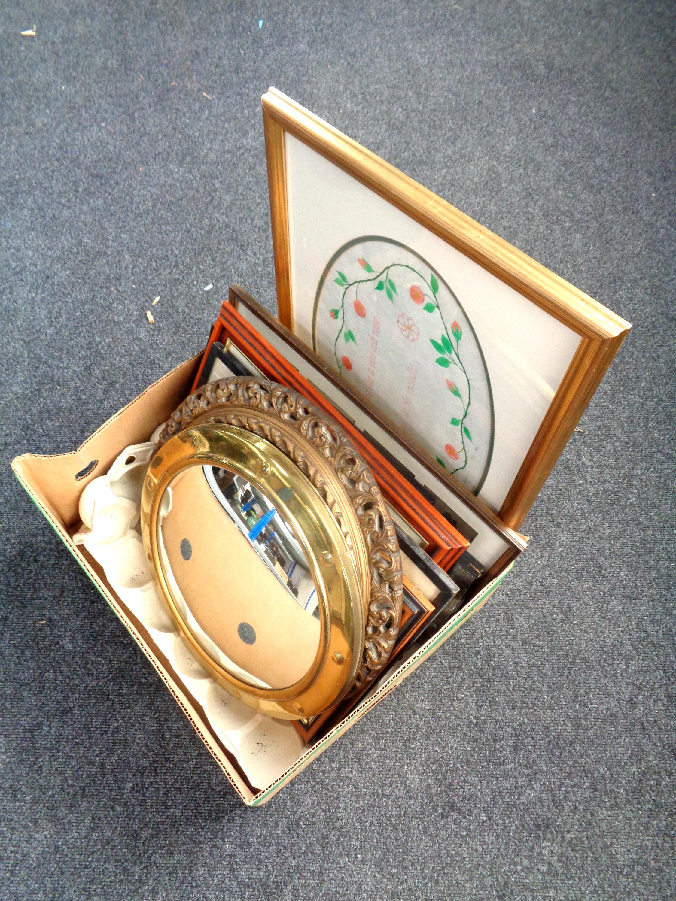A box containing gilt porthole mirror, brass circular mirror, pictures and prints,