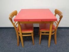 A mid 20th century Melamine pull out kitchen table and two chairs