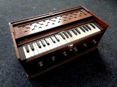 A wooden cased travelling harmonium