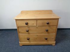 A pine four drawer chest