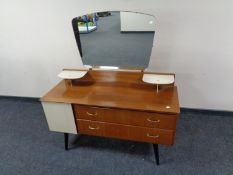 A mid 20th century Lebus Furniture teak mirror back dressing table