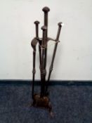 A contemporary wrought metal fire companion set