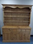 A pine kitchen dresser with plate rack above,