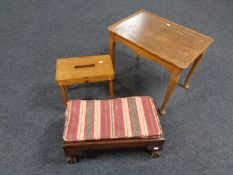 A walnut shaped coffee table together with a foot stool on claw and ball feet and one further stool