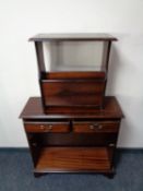 A reproduction mahogany magazine rack with tooled leather top together with a similar two drawer