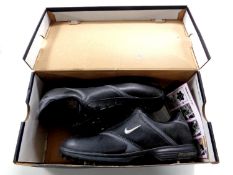 A boxed pair of Nike golf shoes,