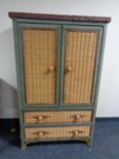 A wicker cabinet fitted two drawers beneath