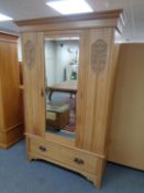 An Edwardian satin wood mirror door wardrobe