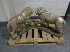 A pair of weathered painted concrete figures - Lions