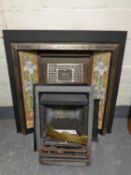 A Victorian style cast iron tiled fire surround and insert