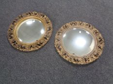 A pair of gilt gesso porthole mirrors