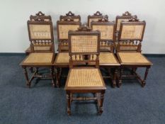 A set of nine carved oak and rattan dining chairs