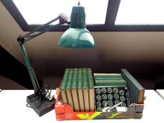 A green angle-poise lamp together with a box containing volumes including Thompson's Gardener's