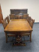 A six piece early 20th century oak dining room suite comprising of buffet back sideboard,