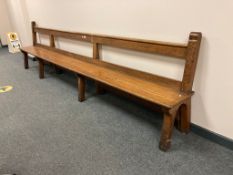 An early 20th century oak pew, length 350 cm,