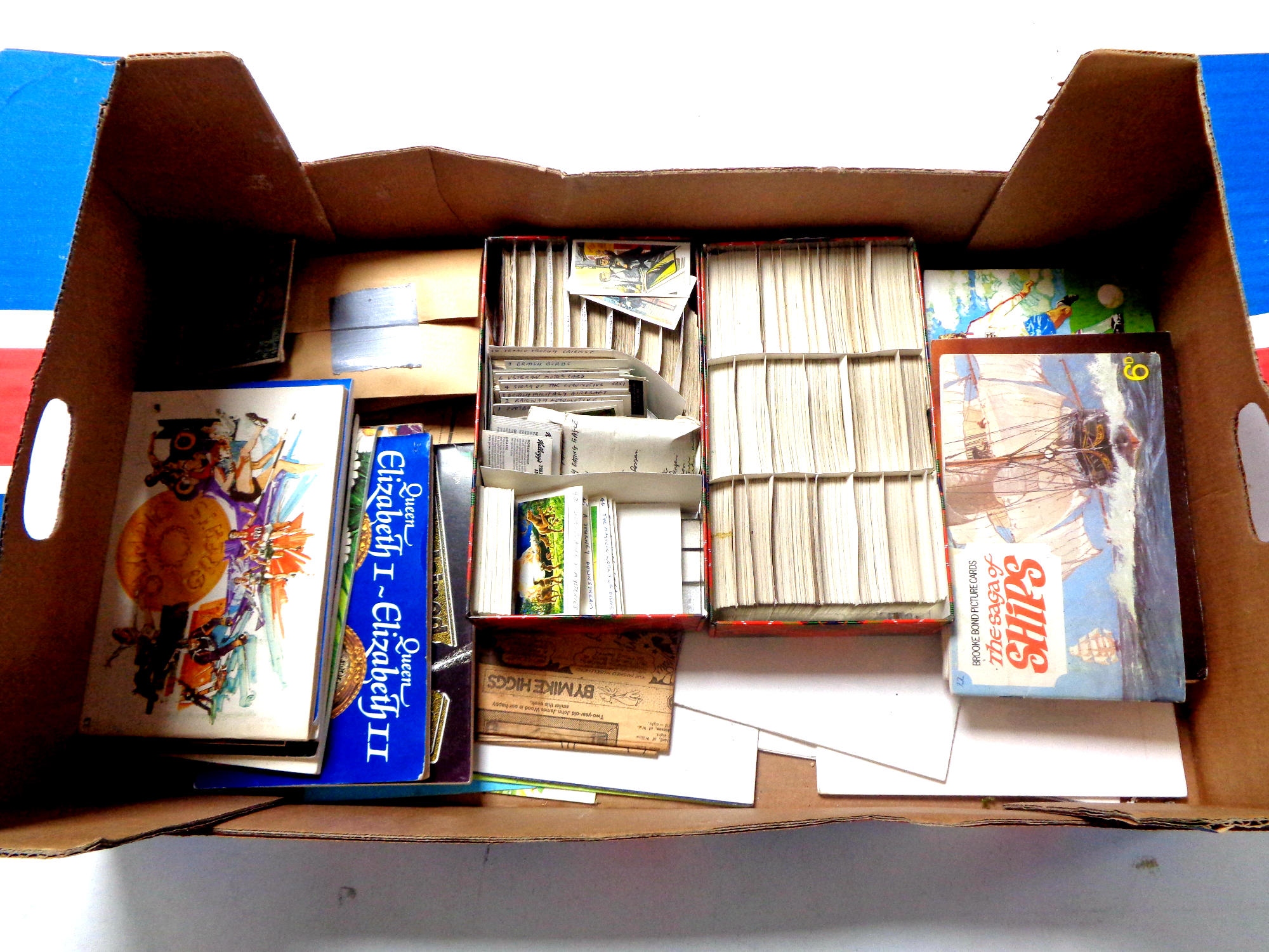 A box containing a quantity of cigarette and tea card albums and cards