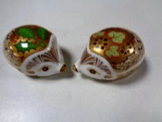 Two Royal Crown Derby china hedgehog paperweights, with gold stoppers,