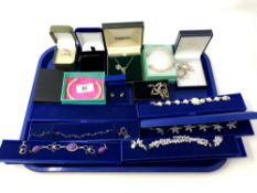 A tray containing a collection of silver jewellery, bangles,