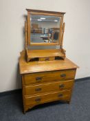 An Edwardian satin wood three drawer dressing chest with mirror back