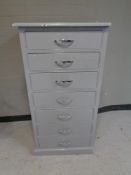 A painted pine narrow seven drawer chest