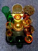 A tray containing a quantity of green and amber glassware