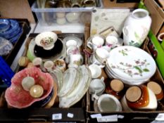 Two boxes of miscellaneous items to include place mats, kitchen storage jars, plates,