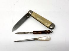 A vintage pen knife together with two small manicure items.