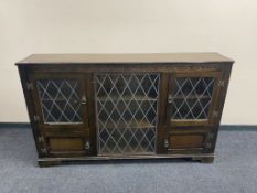 A carved triple door bookcase with leaded glass doors (a/f)