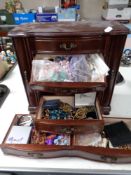 A five drawer dressing table jewellery cabinet containing costume jewellery and threads